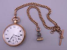 A 9 ct gold cased open faced top wind pocket watch and a 9 ct gold Albert chain. 121.5 grammes.