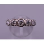 An 18 ct gold five stone diamond ring. Ring size Q/R. 3.9 grammes total weight.