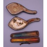 A 19th century cased meerschaum pipe and a cased amber cheroot holder. The latter 11 cm long.