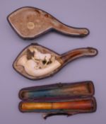 A 19th century cased meerschaum pipe and a cased amber cheroot holder. The latter 11 cm long.