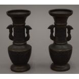 A pair of small 19th century Japanese bronze vases. 14 cm high.