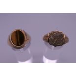 Two 9 ct gold signet rings, one set with tigers eye. 7.9 grammes total weight.