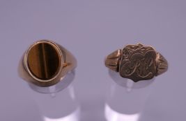 Two 9 ct gold signet rings, one set with tigers eye. 7.9 grammes total weight.