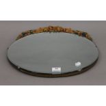 An oval Barbola mirror. 45.5 cm wide.