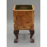 An early 20th century walnut and brass wine cooler. 48 cm high.