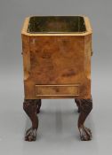 An early 20th century walnut and brass wine cooler. 48 cm high.