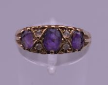 A 9 ct gold diamond and amethyst ring. Ring size L/M. 1.9 grammes total weight.