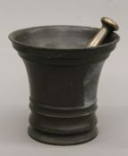 An 18th century bronze pestle and mortar. 15.5 cm high.