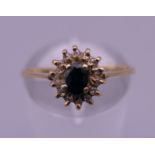 An 18 K gold sapphire and diamond cluster ring. Ring size N/O. 2 grammes total weight.