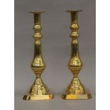 A pair of Edwardian brass candlesticks. 30.5 cm high.