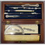 A quantity of Victorian drawing instruments in a fitted wooden box. 19 cm wide.