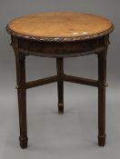 A Victorian mahogany topped cast iron pub table. 59 cm diameter.