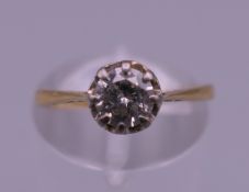 An 18 ct gold and platinum 0.50 carat diamond solitaire ring. Ring size K. 1.8 grammes total weight.