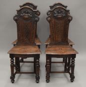 A set of four Victorian carved oak hall chairs. 48 cm wide. En-suite with the following lot.