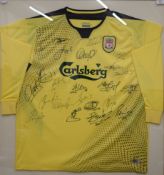 A Liverpool away football shirt signed by: Jerzy Dudek (1), Steve Finnan (3), Jamie Carragher (23),