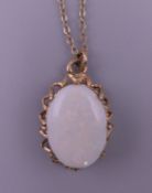 A 9 ct gold and opal pendant on chain. The pendant 2 cm high. 2.8 grammes total weight.