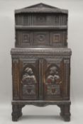 An 18th century and later carved oak cupboard. 89 cm wide x 175 cm high.