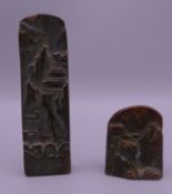 Two Chinese bronze seals depicting mountainous scenes. The largest 9 cm high.