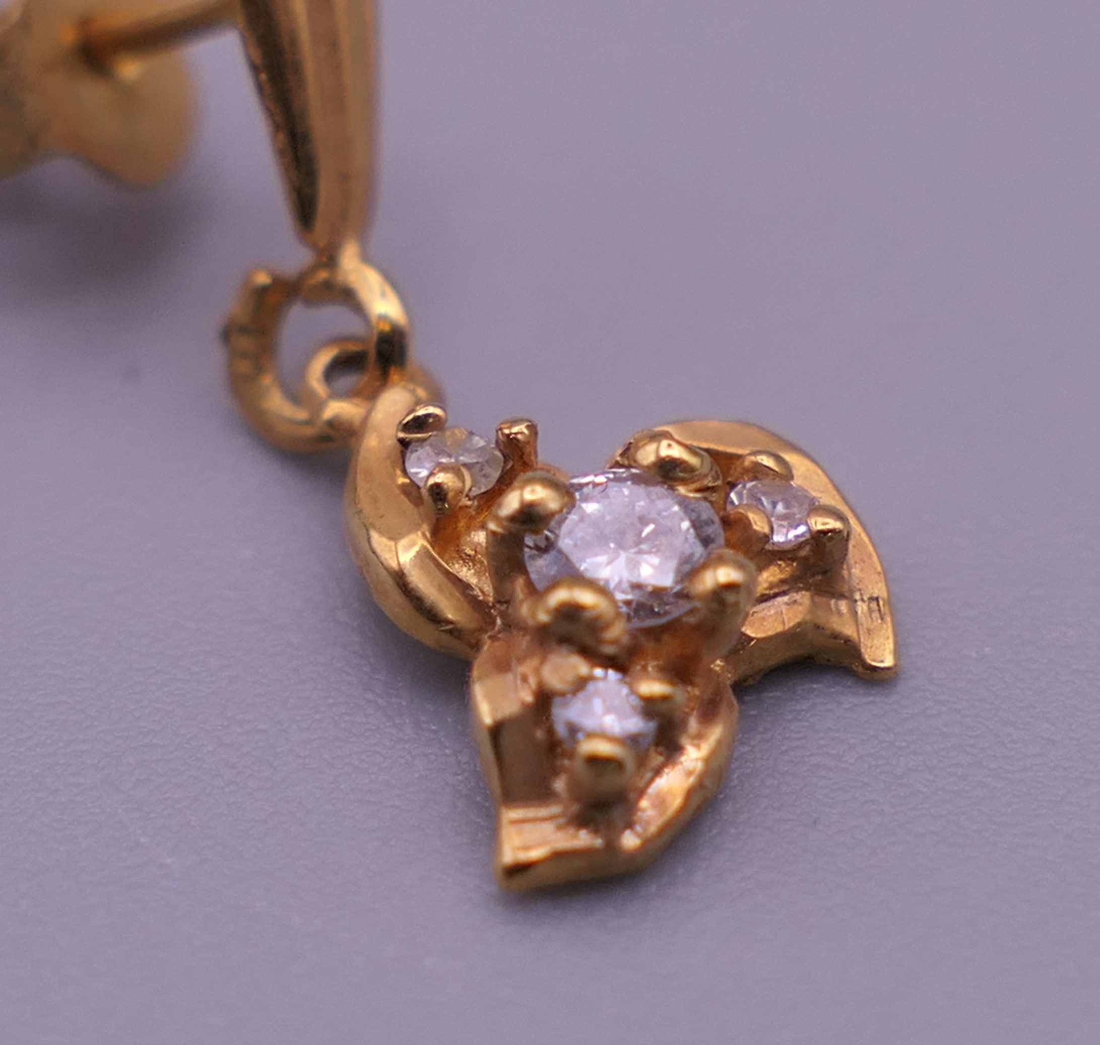 A pair of gold diamond set earrings. 1 cm high. 1.4 grammes total weight. - Image 5 of 5