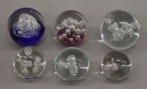 A small collection of paperweights.