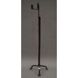 A large antique wrought iron rush light holder. 96 cm high.