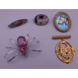 A spider brooch, an agate brooch, a Scottish silver brooch and two vintage dog brooches.