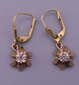 A pair of 9 ct gold diamond set drop earrings. 2 cm high. 3.2 grammes total weight.