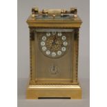A brass cased repeating alarm clock. 18.5 cm high.
