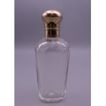 A Continental gold topped cut glass scent bottle. 9 cm high.