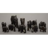 A collection of small carved wooden elephants. The largest 5 cm high.
