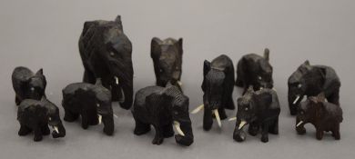 A collection of small carved wooden elephants. The largest 5 cm high.