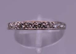 An 18 ct white gold nine stone diamond ring. Ring size O/P. 2.2 grammes total weight.