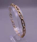 A 9 ct gold and diamond bracelet. 19 cm long. 12.6 grammes total weight.