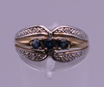 A 9 ct gold diamond and sapphire ring. Ring size L. 1.9 grammes total weight.