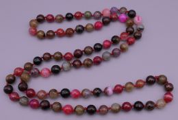 An agate and specimen stone bead necklace. 118 cm long.