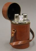 A set of three leather cased spirit flasks. 18.5 cm high overall.