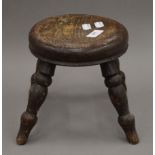 A 19th century milking stool. 19.5 cm high.