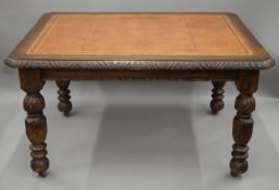 A Victorian carved oak table with leather inset top. 136 cm long x 105 cm wide.