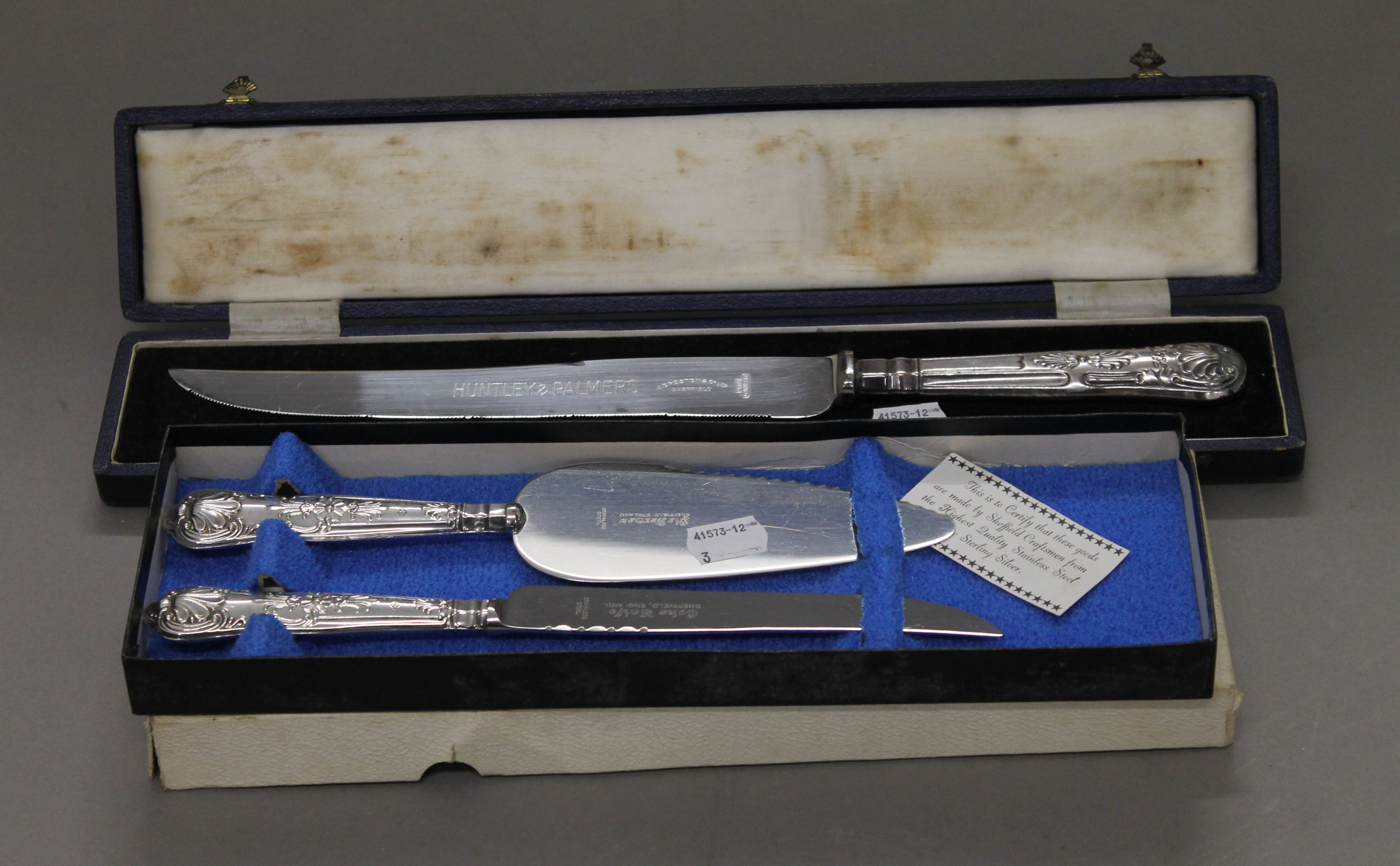 A cased silver plated cake knife inscribed for Huntley and Palmers,