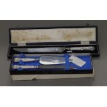 A cased silver plated cake knife inscribed for Huntley and Palmers,