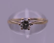 A 9 K gold 0.25 carat diamond solitaire ring. Ring size M. 1.1 grammes total weight.