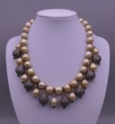 A pearl and diamond set drop necklace. 39 cm long.