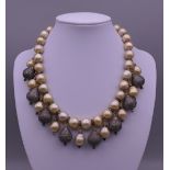 A pearl and diamond set drop necklace. 39 cm long.