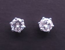 A pair of 18 ct white gold and diamond studs. 4 mm diameter.