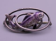 A Charles Horner silver brooch with enamelled fish, dated 1904. 3 cm wide.