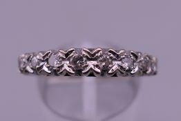 An 18 ct white gold eight stone diamond ring. Ring size P/Q. 4 grammes total weight.