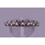 An 18 ct white gold eight stone diamond ring. Ring size P/Q. 4 grammes total weight.