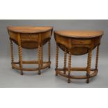 A pair of oak barley twist demi-lune single drop leaf tables. Each 78 cm wide.