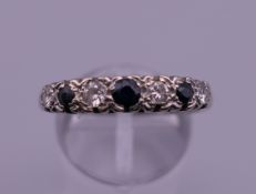 A platinum diamond and sapphire ring. Ring size S. 4.7 grammes total weight.