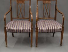A pair of Edwardian line inlaid mahogany open arm chairs. 54 cm wide.